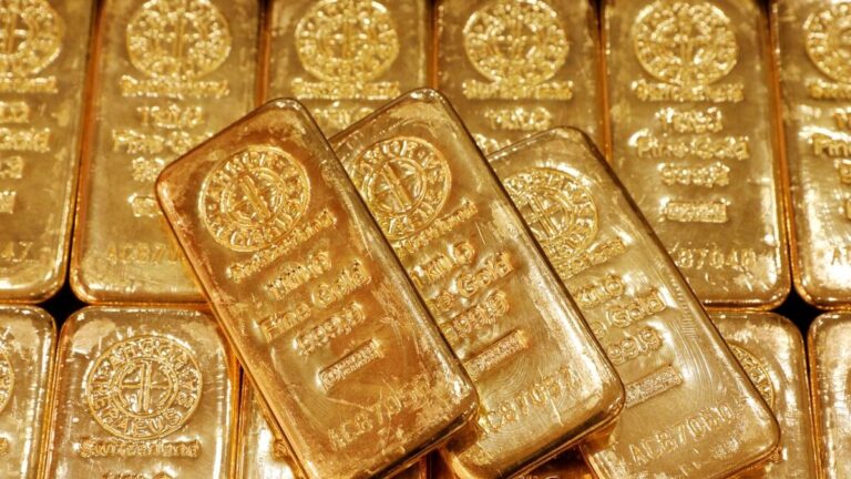 Gold Loses Shine in UAE: Prices Drop Further Close-up image of several gold bars stacked together, some appearing slightly discolored.