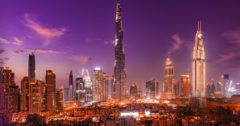 A stunning view of Dubai's skyline featuring iconic landmarks like the Burj Khalifa and modern skyscrapers, symbolizing the city's real estate market and urban development.