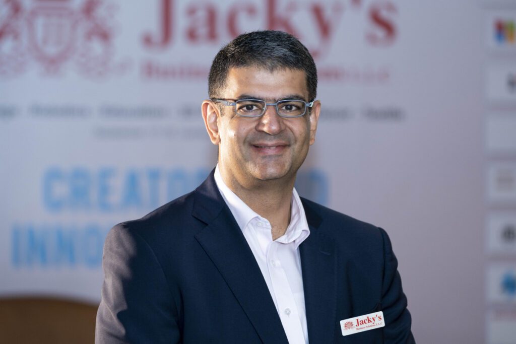 Portrait of Ashish Panjabi in formal attire, representing his leadership in digital transformation and innovative technology.