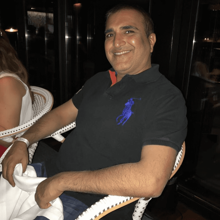 Portrait of Deepak Pagarani in formal attire, representing his leadership at Al Maya Group.