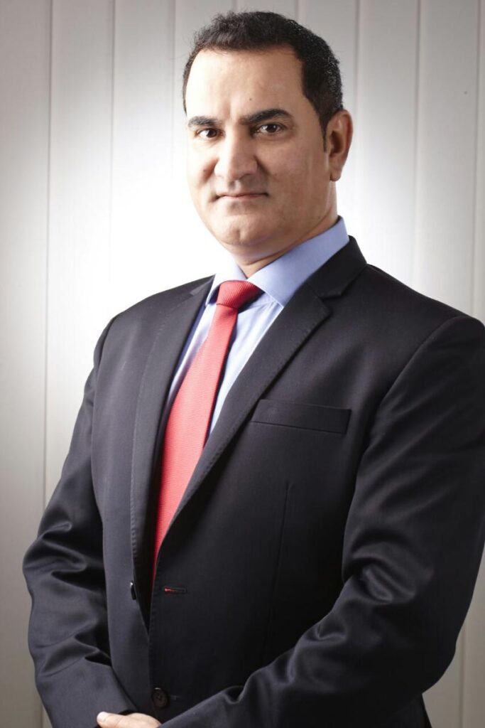 Portrait of Harish Tahiliani in formal attire, representing his transformative leadership at Arab India Spices.