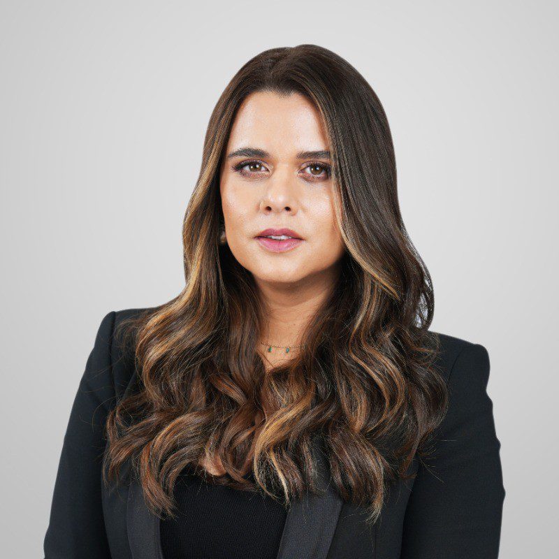 Portrait of Nisha Jagtiani in formal attire, representing her innovative leadership in the retail sector.