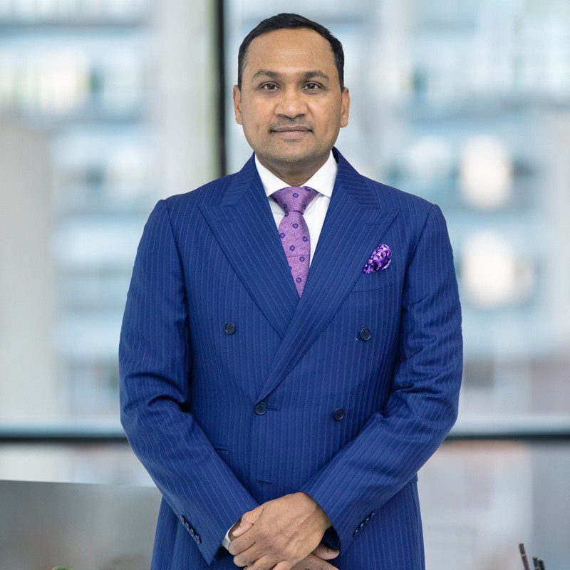Portrait of Taher Shams in formal attire, representing his transformative leadership in healthcare innovation and sustainability.